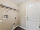 Bright laundry room featuring wood-look flooring, shelving and a neutral color palette at 5048 Teather St, Spring Hill, FL 34608