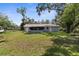 Spacious backyard showcasing the home's layout and screened-in porch at 5215 Azalea Cir, Dade City, FL 33523