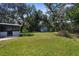 Expansive backyard with a shed, shaded by mature trees, perfect for relaxing at 5215 Azalea Cir, Dade City, FL 33523