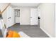 Bright bedroom with gray flooring, multiple doors, and natural light offers versatile living space at 5215 Azalea Cir, Dade City, FL 33523
