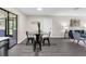 Open dining area with a glass table, black chairs, and sliding glass doors to a screened-in porch at 5215 Azalea Cir, Dade City, FL 33523