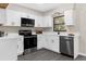 Modern kitchen featuring stainless steel appliances, and white cabinets at 5215 Azalea Cir, Dade City, FL 33523