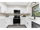 Modern kitchen with white cabinets, quartz countertops, and stainless steel appliances at 5215 Azalea Cir, Dade City, FL 33523