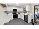 Modern kitchen with white cabinets, stainless steel appliances, and a black faucet and sink at 5215 Azalea Cir, Dade City, FL 33523