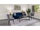 Cozy living room with a blue sofa, neutral walls, decorative pillows, and modern decor at 5215 Azalea Cir, Dade City, FL 33523