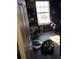 Untidy bedroom with a window, bookcase, and dark floors; the room awaits renovation and personal touches at 5420 Bay Blvd, Port Richey, FL 34668