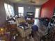 Cluttered living room with hardwood floors, a ceiling fan, and natural light, awaiting personal touches at 5420 Bay Blvd, Port Richey, FL 34668