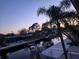 Picturesque view of the canal at dusk, complete with docks, boats, and silhouettes of trees against the sky at 5420 Bay Blvd, Port Richey, FL 34668