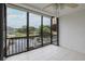 Enclosed balcony features water views, tiled floor, ceiling fan, and black metal railings at 5640 Ferguson Ct # 2203, New Port Richey, FL 34652
