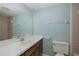 Bathroom featuring a well-lit vanity, a toilet, and a tiled shower at 5640 Ferguson Ct # 2203, New Port Richey, FL 34652