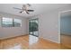 Bedroom with hardwood floors, a ceiling fan, and sliding glass doors to lanai at 5640 Ferguson Ct # 2203, New Port Richey, FL 34652