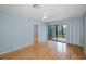 Bedroom featuring hardwood floors and a ceiling fan with access to the balcony at 5640 Ferguson Ct # 2203, New Port Richey, FL 34652