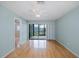 This bedroom features hardwood floors and a sliding glass door to the screened porch at 5640 Ferguson Ct # 2203, New Port Richey, FL 34652