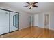 Spacious bedroom with hardwood floors, sliding glass doors to the lanai, and a view to the bathroom at 5640 Ferguson Ct # 2203, New Port Richey, FL 34652