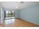 Bedroom with ceiling fan, hardwood floors, and sliding glass doors leading to the balcony at 5640 Ferguson Ct # 2203, New Port Richey, FL 34652