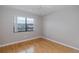 Bright bedroom with hardwood floors, a ceiling fan, and a large window for natural light at 5640 Ferguson Ct # 2203, New Port Richey, FL 34652