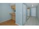Hallway with tile and hardwood floors, leading to the kitchen at 5640 Ferguson Ct # 2203, New Port Richey, FL 34652