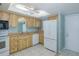 Galley kitchen featuring wood cabinets and light countertops at 5640 Ferguson Ct # 2203, New Port Richey, FL 34652