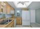 Functional kitchen with essential appliances, cabinetry, and a tile floor for easy maintenance at 5640 Ferguson Ct # 2203, New Port Richey, FL 34652