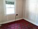 Bedroom with red carpet, wood trim and a small window at 5748 Montana Ave, New Port Richey, FL 34652