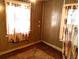 A modest bedroom with animal print curtains and wood paneling at 5748 Montana Ave, New Port Richey, FL 34652