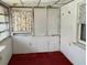 Room with red carpet, white walls and ceiling, and a small window at 5748 Montana Ave, New Port Richey, FL 34652