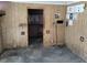 Empty room with wood paneling, concrete floors, and utility access at 5748 Montana Ave, New Port Richey, FL 34652