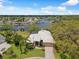 Panoramic aerial view of a beautiful home with landscaping, a waterway, and neighborhood at 5903 Cachette De Riviera Ct, New Port Richey, FL 34655
