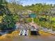 Aerial view features a house with a dock, a sitting area, and jet skis for water activities at 5903 Cachette De Riviera Ct, New Port Richey, FL 34655