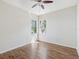 Bright bedroom features hardwood floors, ceiling fan and two windows offering natural light at 5903 Cachette De Riviera Ct, New Port Richey, FL 34655