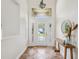 Bright foyer with tile flooring, transom window, and modern decor at 5903 Cachette De Riviera Ct, New Port Richey, FL 34655