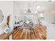 Bright living room with hardwood floors, a chandelier, skylight, and glass doors at 5903 Cachette De Riviera Ct, New Port Richey, FL 34655