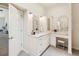 Bright main bathroom features white cabinets, marble countertops, vanity, and doorway to the bedroom at 5903 Cachette De Riviera Ct, New Port Richey, FL 34655