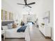 Bright main bedroom features gray and white decor, tile floor, ceiling fan, and sliding glass door to the pool at 5903 Cachette De Riviera Ct, New Port Richey, FL 34655