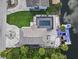 Beautiful aerial view of a home featuring a pool, canal access, and lush greenery at 6241 Colony Cir, Weeki Wachee, FL 34607