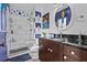 Bathroom with glass-enclosed shower, vanity, and whimsical decorations at 6241 Colony Cir, Weeki Wachee, FL 34607