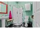Compact bathroom featuring a stand-up shower, pedestal sink, and toilet at 6241 Colony Cir, Weeki Wachee, FL 34607