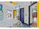 Bright bedroom with TV, tropical decor, and a glimpse into adjoining rooms at 6241 Colony Cir, Weeki Wachee, FL 34607