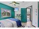 Bedroom with blue accents, dresser, and TV mounted on the wall at 6241 Colony Cir, Weeki Wachee, FL 34607