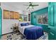 Comfortable bedroom with blue accents, map decor, and natural light at 6241 Colony Cir, Weeki Wachee, FL 34607
