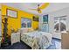 Tropical themed bedroom featuring yellow walls and decor, with two windows at 6241 Colony Cir, Weeki Wachee, FL 34607