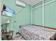 Cozy bedroom with a TV, patterned bedding, and a seaside mural at 6241 Colony Cir, Weeki Wachee, FL 34607