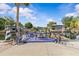 Waterfront property featuring a spacious dock, seating, and a charming lighthouse replica with lovely canal views at 6241 Colony Cir, Weeki Wachee, FL 34607