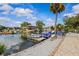 Waterfront featuring a private boat dock, boat, and meticulous landscaping with a decorative lighthouse at 6241 Colony Cir, Weeki Wachee, FL 34607