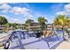 A private dock with a swing, outdoor seating, and waterfront access, perfect for relaxing and enjoying the tranquil scenery at 6241 Colony Cir, Weeki Wachee, FL 34607