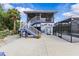 The house has backyard access with a screen porch, an exterior stairway, and a screened-in pool area at 6241 Colony Cir, Weeki Wachee, FL 34607