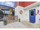 Charming home exterior with a colorful entrance, pool, and decorative landscaping at 6241 Colony Cir, Weeki Wachee, FL 34607