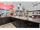 Kitchen features a granite countertop, stylish cabinets, and access to the living room and outdoor space at 6241 Colony Cir, Weeki Wachee, FL 34607