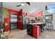 The kitchen featuring stainless steel refrigerator and breakfast bar with chairs at 6241 Colony Cir, Weeki Wachee, FL 34607