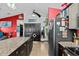Spacious kitchen and living area with breakfast bar and seating with stainless steel refrigerator at 6241 Colony Cir, Weeki Wachee, FL 34607